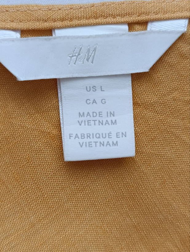تاپ زنانه لینن برند H&M استوک اورجینال رنگ نارنجی نمای اتیکت و برند
