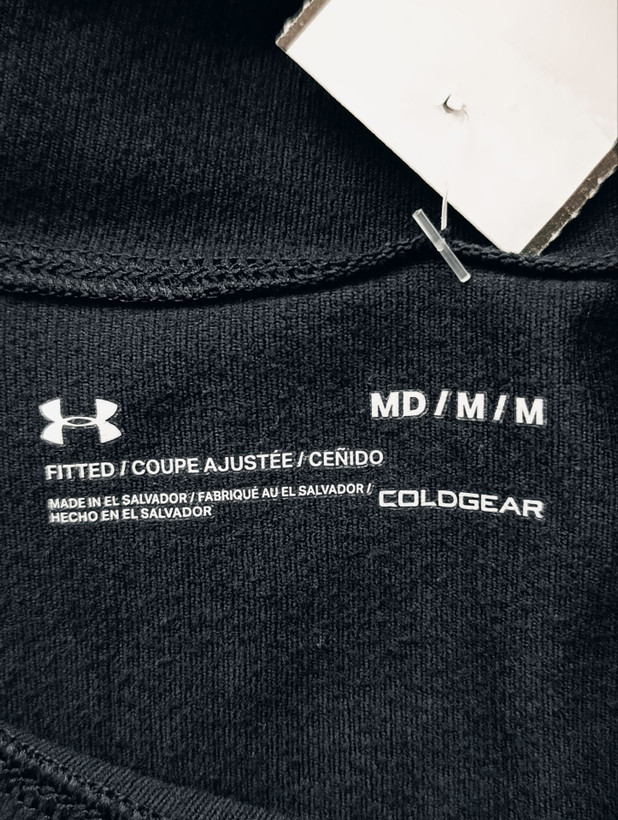 لباس ورزشی برند UNDER ARMOUR استوک اورجینال رنگ مشکی نمای اتیکت برند