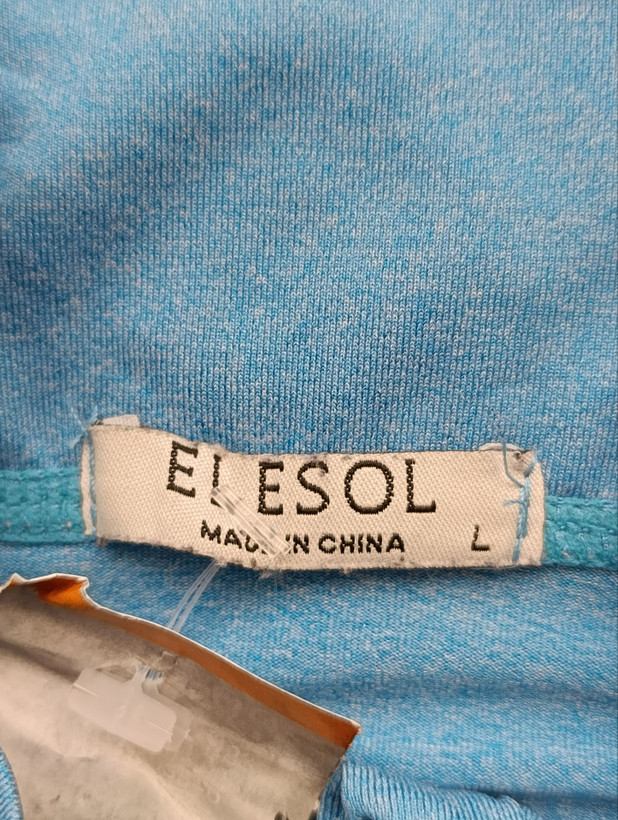 لباس ورزشی زنانه برند ELESOL استوک اورجینال رنگ فیروزه ای نمای اتیکت برند